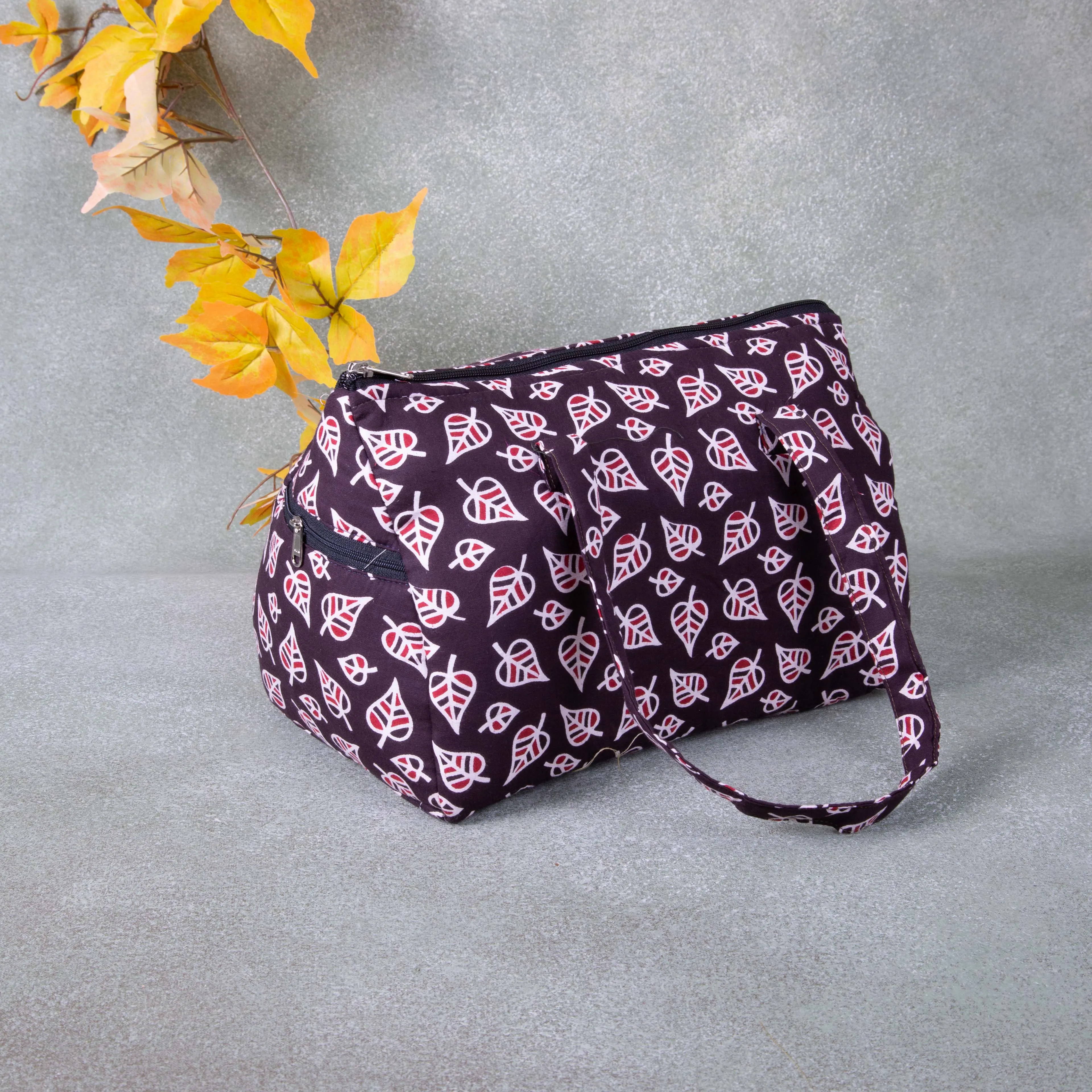 Barrel Handbags Maroon Colour with Leaf Design.